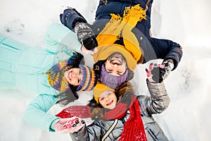 High angle view photo of happy excited cheerful family lying on ground snow having fun winter holiday vacation