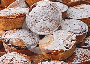 High-angle view of a pile of delicious Christmas mince pies with sugar powder on top