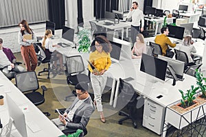 High angle view of professional young businesspeople working with computers and documents