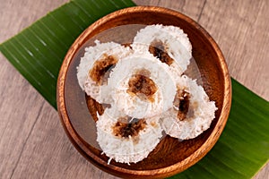 Putu bambu or steamed rice flour cake with grated coconut and palm sugar filling photo