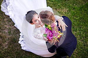 High angle view of romantic wedding couple on grassy field