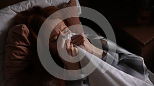 High-angle view of sad sorrowful young woman crying lying alone on bed under blanket, have depression and stress