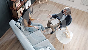 High angle view of separated couple quarreling in psychologist's office feeling angry