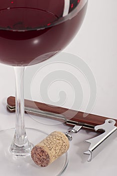High angle view with shallow depth of field of a glass of red wine with a sommelier tools