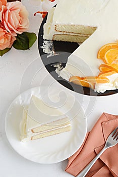 High angle view sliced vanilla cake with orange slices