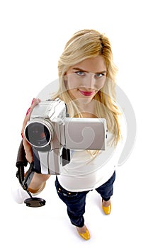 High angle view of smiling model with camcorder