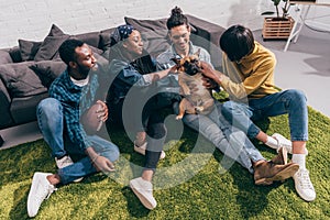 high angle view of smiling young multicultural friends with french