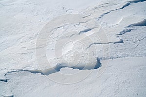 High angle view of snowflakes texture on sunny day