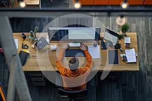 Top view of software developer working on a laptop at home