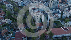 High angle view of streets and buildings in residential urban borough in city at twilight. Cars and tram passing in