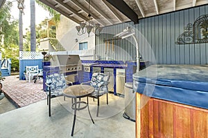 High angle view of a stylish outdoor kitchen on a brick patio wi