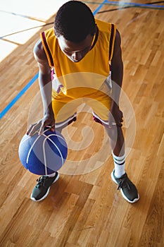 High angle view teenage boy practicing basketball