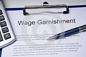 High Angle View Of Wage Garnishment Documents With Calculator An photo