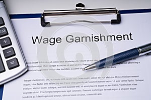 High Angle View Of Wage Garnishment Documents With Calculator An