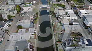High angle view of water canal surrounded by family houses in city. Dense town development in Venice residential