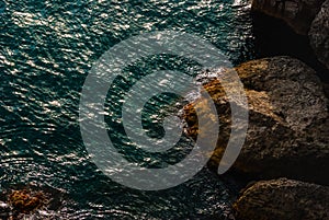 High angle view of water and rock cliff