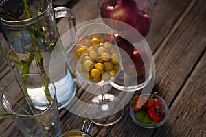 High angle view of winter cherry and apples in container