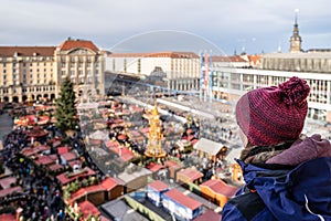 High-angle view of a woman admiring the festive atmosphere of Striezelmarkt