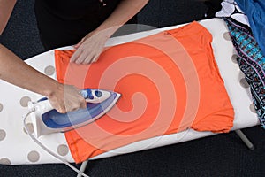 High angle view of woman ironing on ironing board