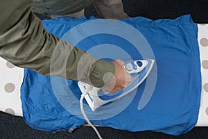 High angle view of woman ironing on ironing board