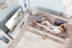 High Angle View Of Woman Watching Television