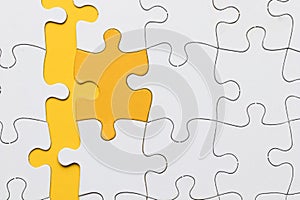 high angle view yellow puzzle piece arranged with white pieces. High quality photo