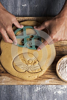 Man preparing skull-shaped cookies photo