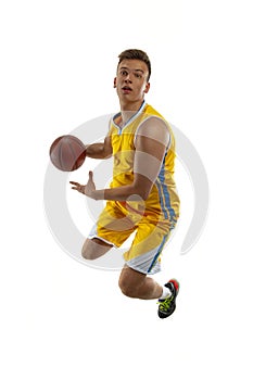 High angle view of young man, basketball player with a ball training isolated on white studio background. Advertising