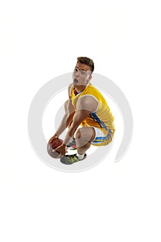 High angle view of young man, basketball player with a ball training isolated on white studio background. Advertising