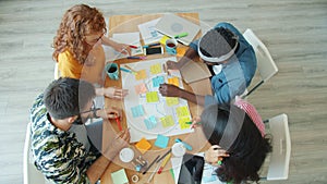 High angle view of young people multi-ethnic group doing collage in office