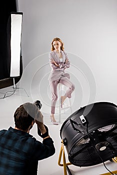 high angle view of young photographer shooting beautiful female model