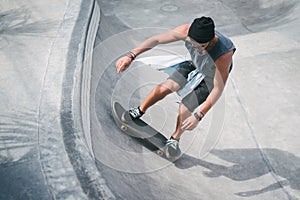 high angle view of young skater skating in pool