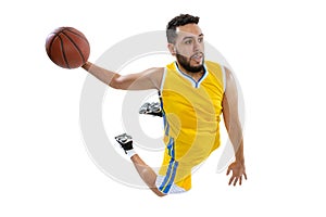 High angle view of young sportive man, professional basketball player jumping with ball isolated on white background