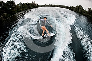 High angle view of young woman actively riding on wave
