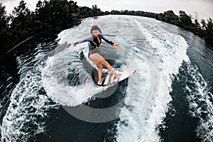 High angle view of young woman energetically riding on wave