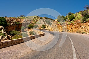 High atlas mountains in Morocco, North Africa. Empty asphalt road, beautiful landscape, sunny day