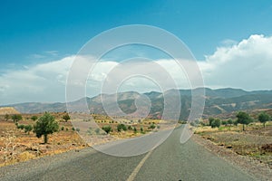 High atlas mountains in Morocco, North Africa. Empty asphalt road, beautiful landscape, sunny day