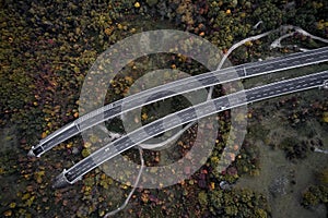 High autumn alpine speed road in Italia with exit or enter into the tunnel. Aerial view from above