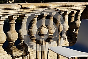 High bar chairs in closeup view on open terrace wih old stone balustrade background