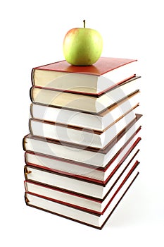 High books pyramid with green apple on top