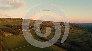 High Bradfield village aerial footage. English Countryside low orange sunset