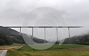 High bridge over wooded hills and meadows