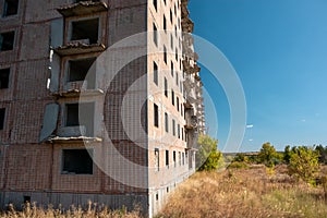 High building facade with tiled facade in autumn photo