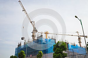 High building under construction with cranes working