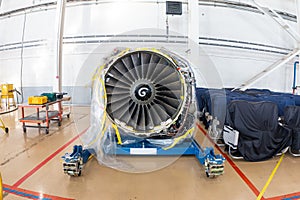 High-bypass turbofan aircraft engine in aviation hangar