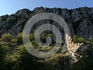 high cliff with abandoned structure