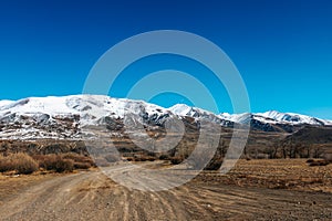 High cliffs in the mountains with snow on the peaks in Altai