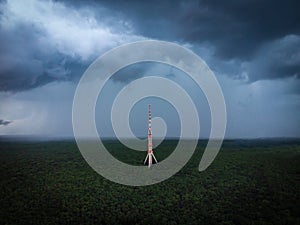 High communications tower antenna in the forest drone view