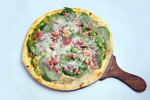 `A high contrast Hero shot of a Bruschetta Al Pesto Spinaci Pizza, on a minimal white background with a 90 degree angle from zoome