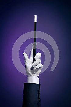 High contrast image of magician hand with magic wand